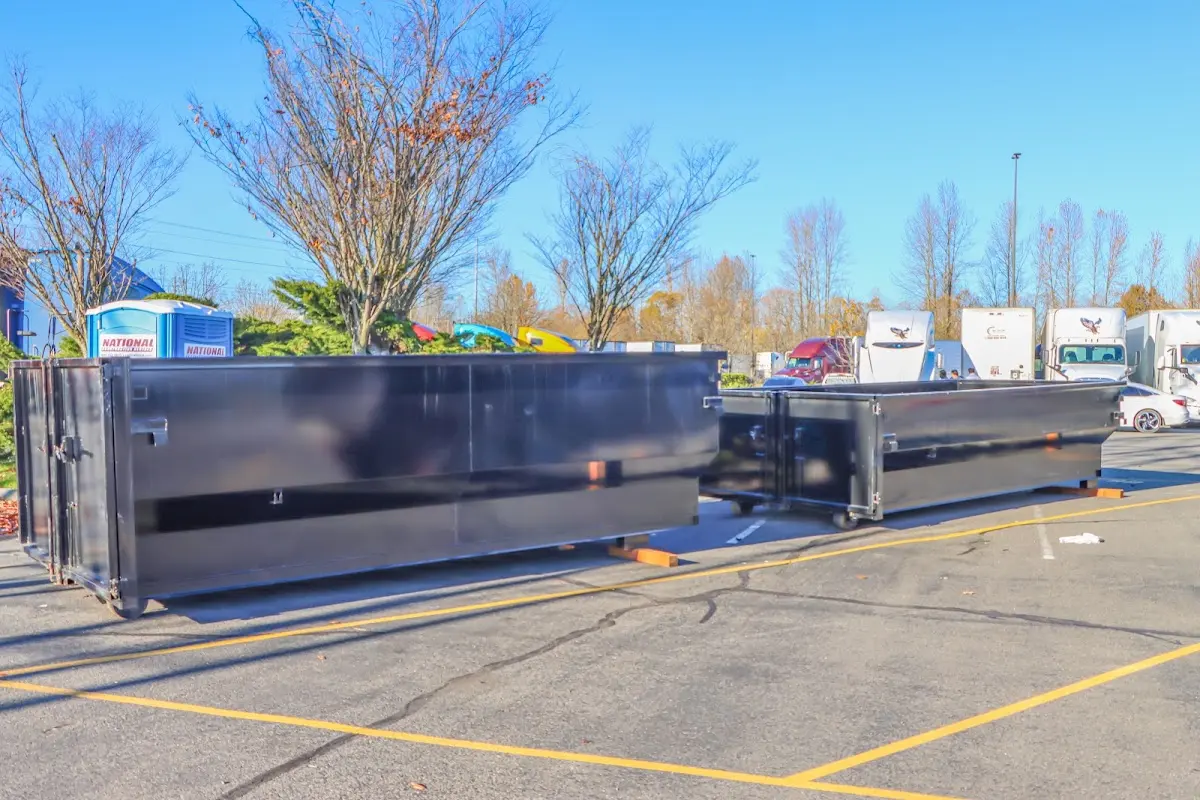 Professional dumpster rental service with roll-off container on residential driveway in Florin